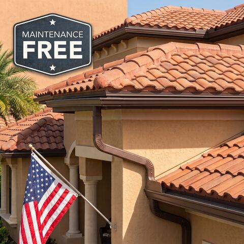 Seamless gutter and downspout installed along a tile roofline